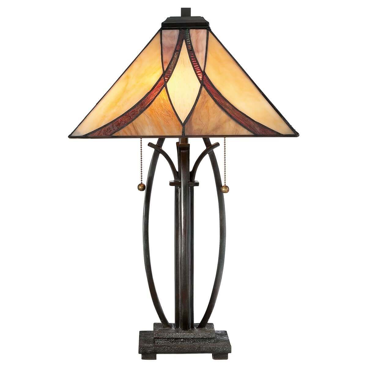 Lampe complète de face sur fond blanc, abat-jour en verre coloré et base métallique ouvragée.