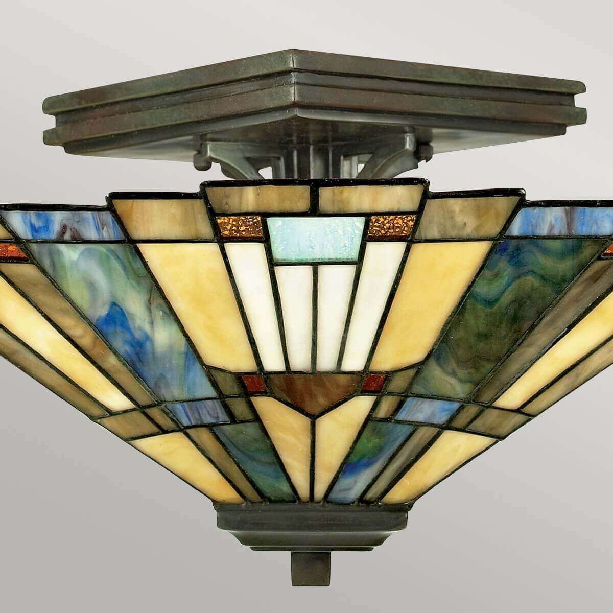 Vue rapprochée du centre montrant la fixation bronze et le verre jaune ivoire