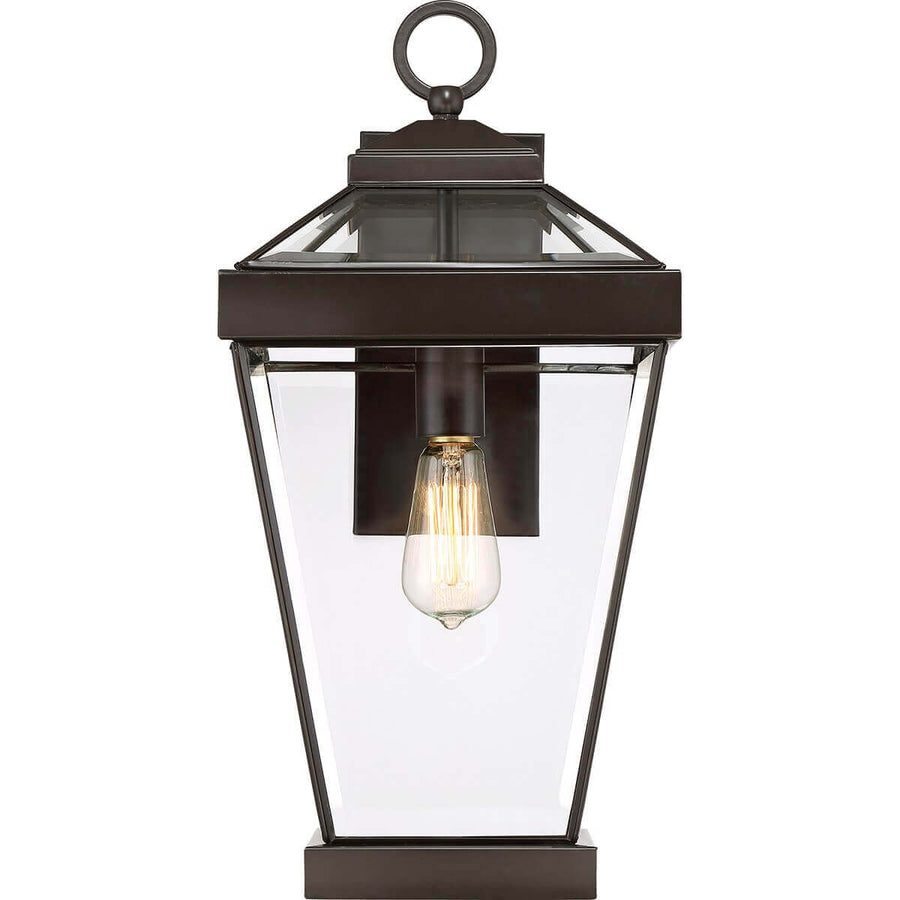 Luminaire présenté bien de face, ampoule à filament allumée et monture métal foncé