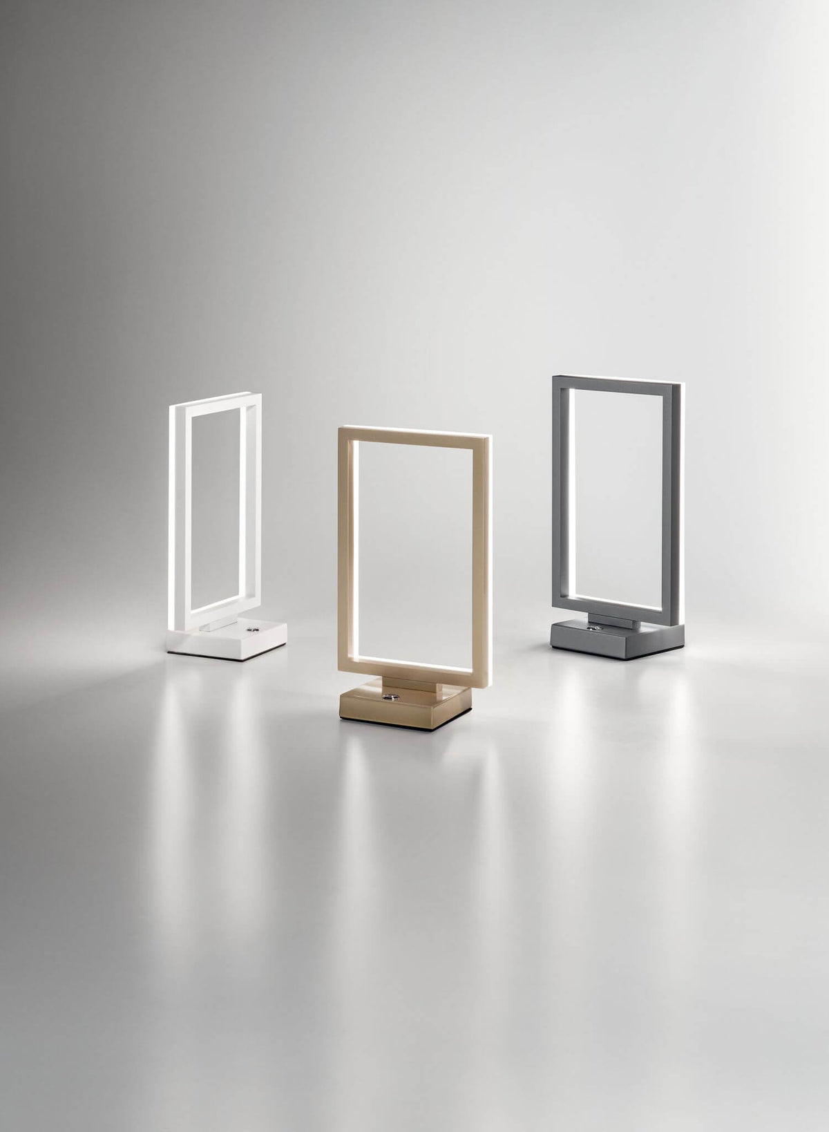 Trois lampes blanches, dorées et grises alignées, vue d'ensemble de la gamme