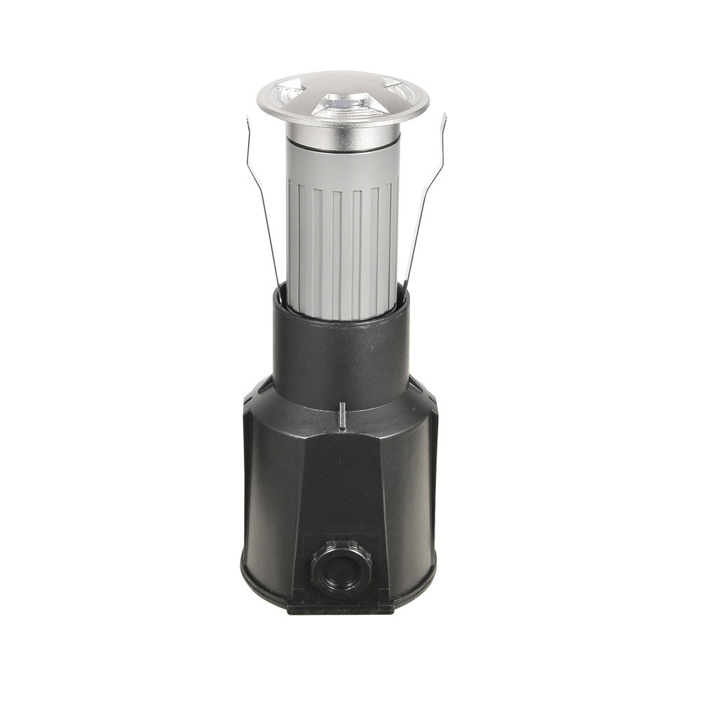 Vue de trois quarts du luminaire encastré, corps noir et collerette inox, ressorts apparents