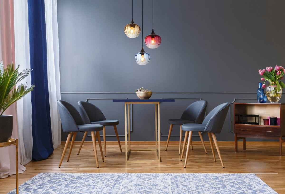 Mise en ambiance dans une salle à manger moderne avec table et chaises grises.