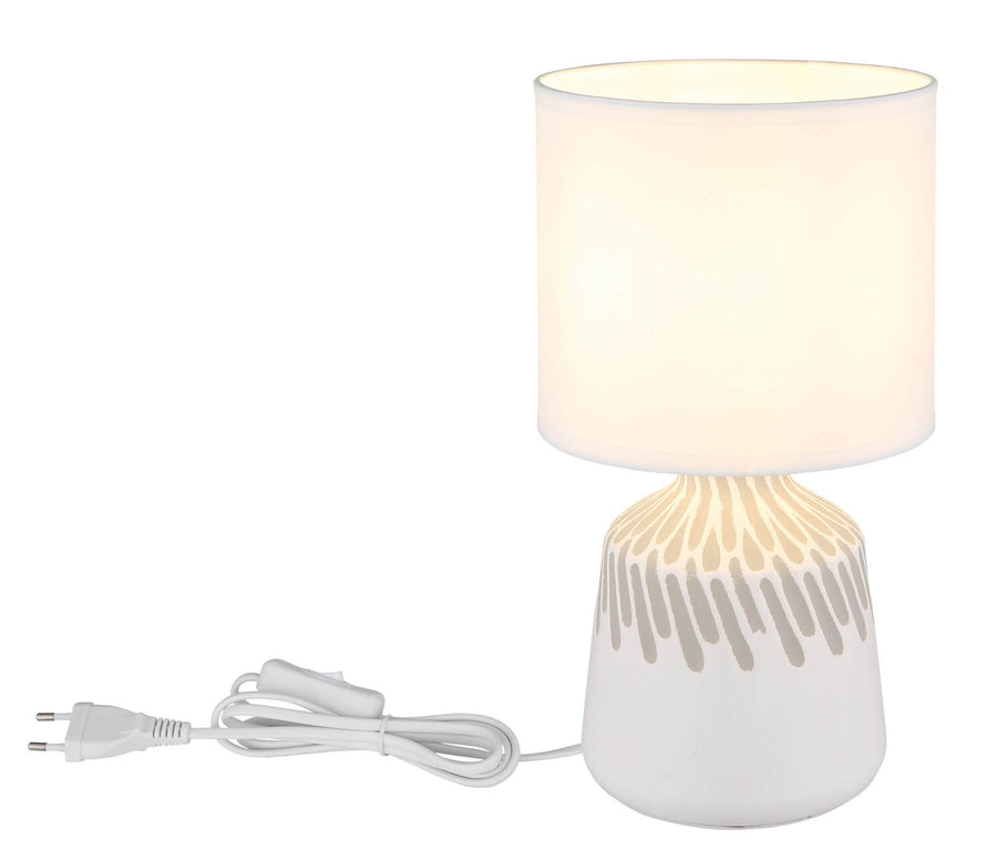 Lampe présentée avec son câble et sa fiche électrique blanche enroulés.