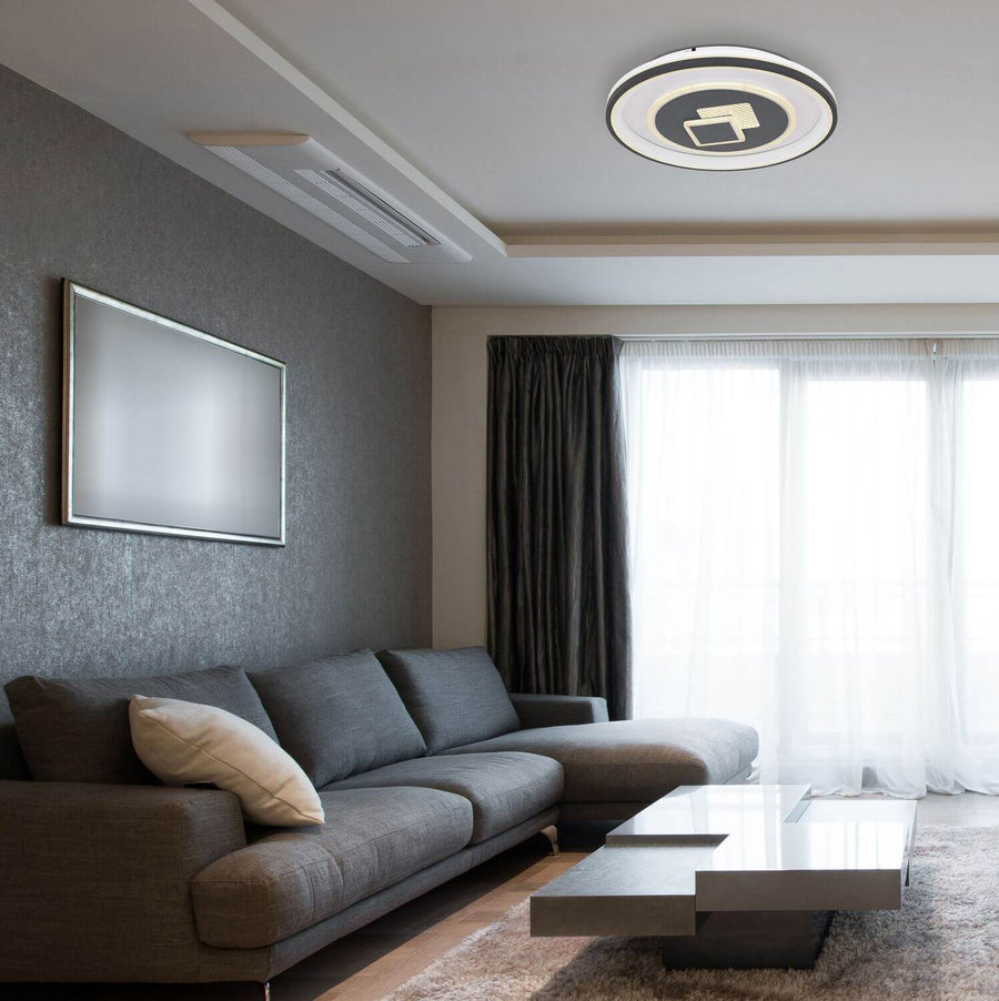 Plafonnier installé au plafond dans un salon moderne avec canapé gris.