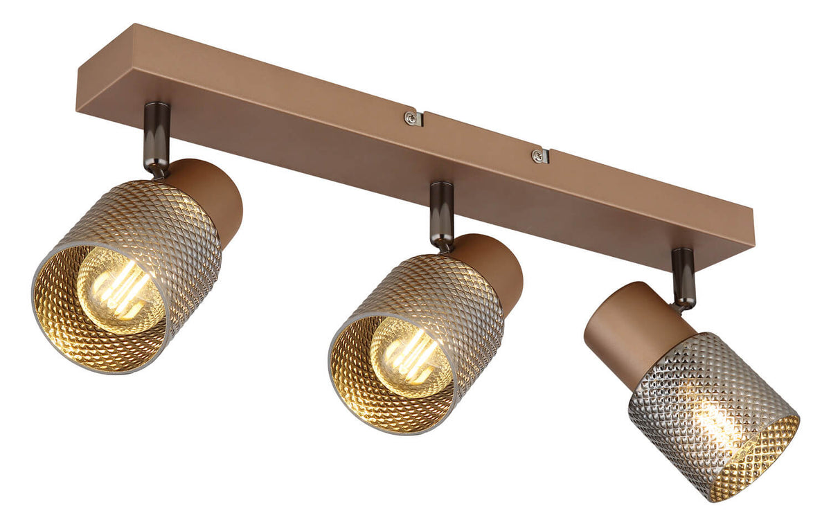 Vue rapprochée du spot triple marron avec têtes cylindriques et ampoules allumées.