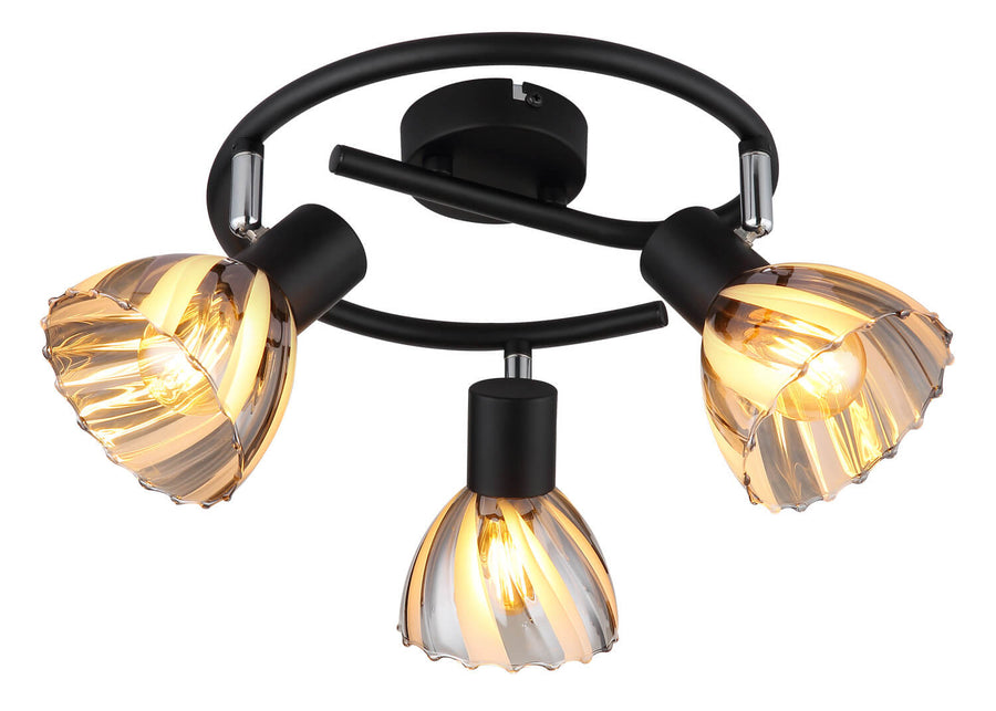 Gros plan du luminaire allumé montrant le verre strié ambré et les fixations