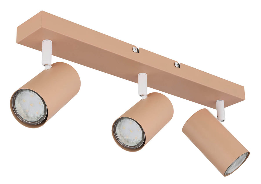 Vue rapprochée des trois spots cylindriques beige rosé orientés vers le bas