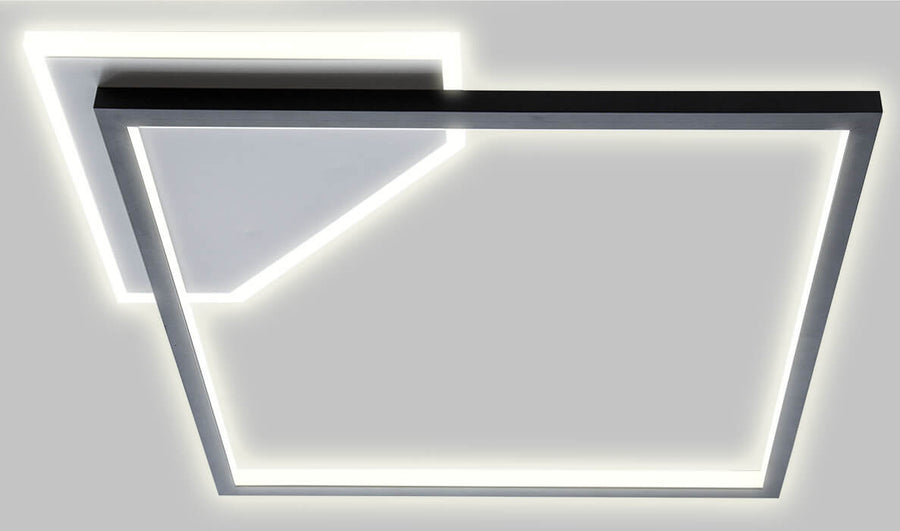 Détail rapproché du luminaire montrant la jonction des profilés et le halo lumineux