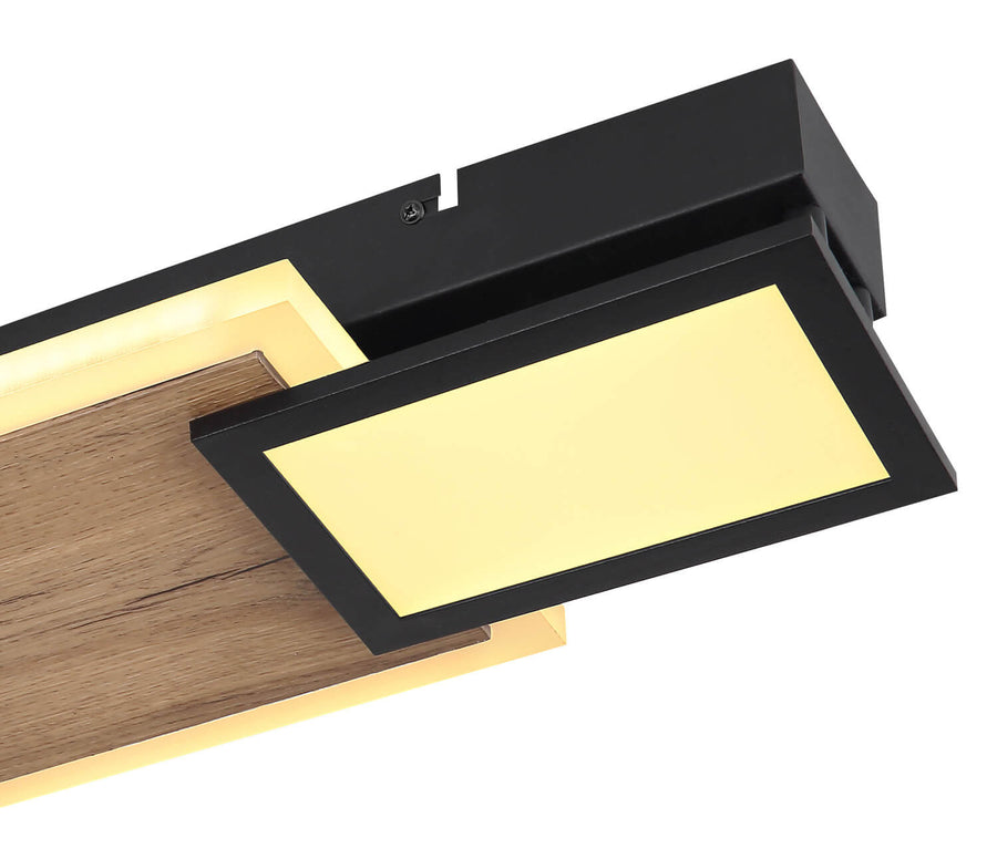 Détail rapproché du cadre noir mat, vis apparentes et texture du bois, panneau LED allumé.