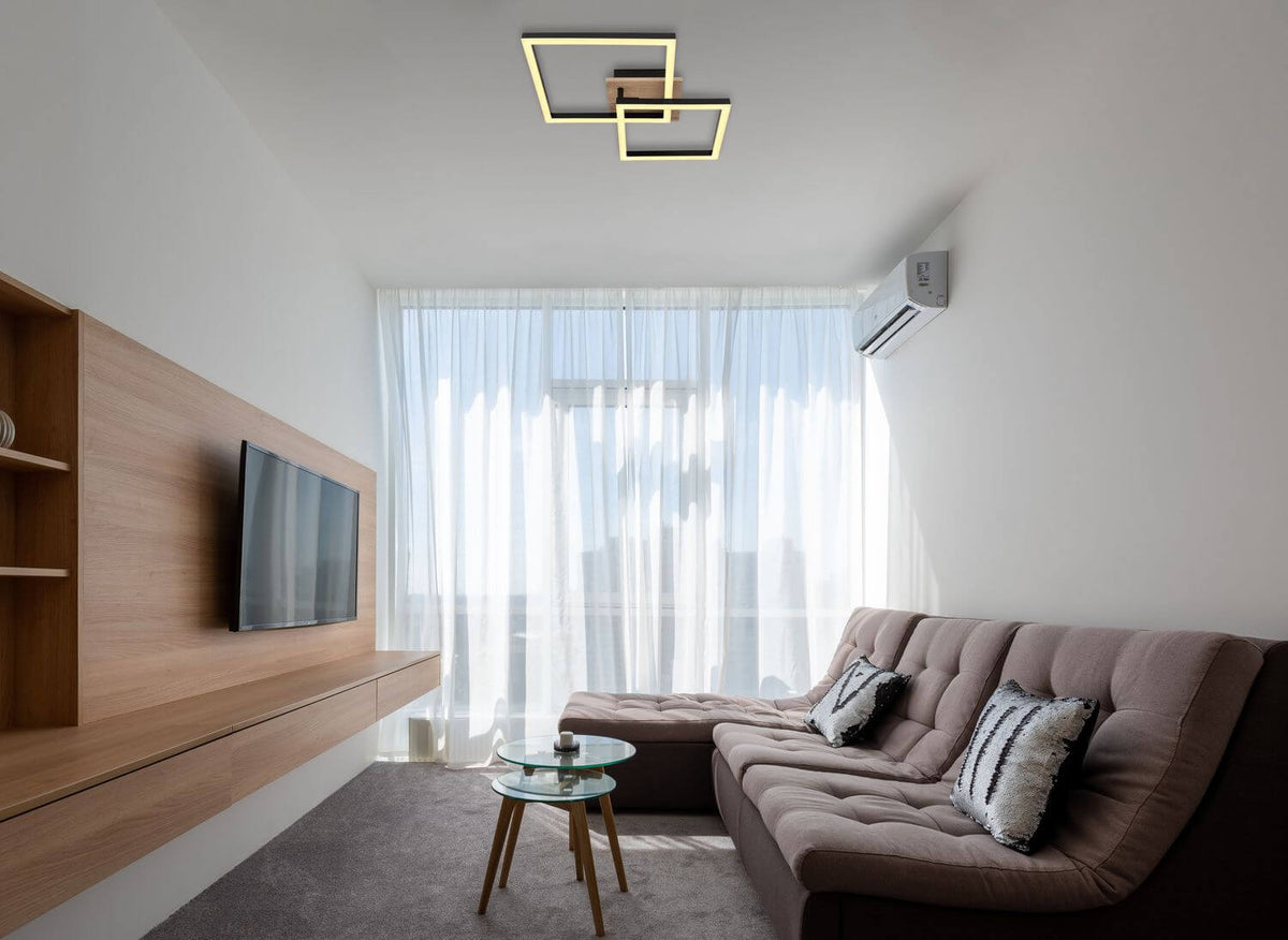 Mise en ambiance dans un salon moderne, plafonnier allumé au-dessus du canapé