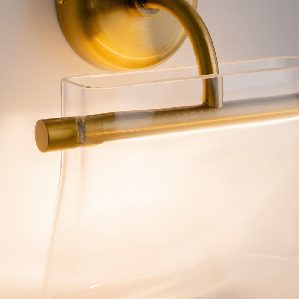 Gros plan sur la finition laiton brossé et le verre transparent du luminaire