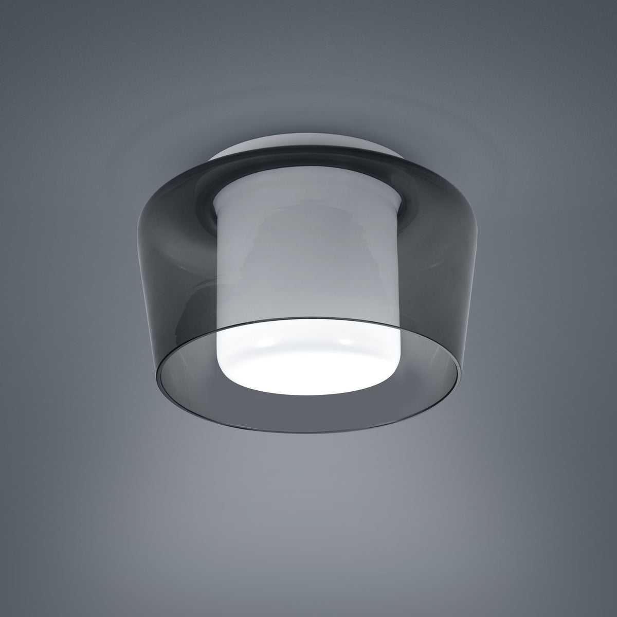 Détail de la finition montrant le double abat-jour en verre et la lumière allumée