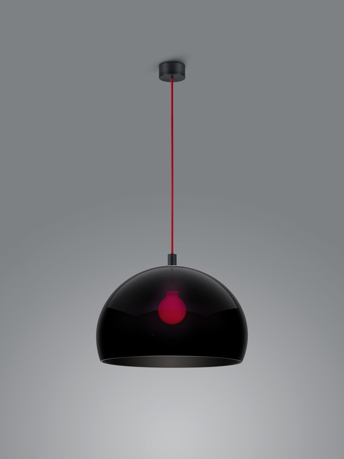Vue rapprochée du luminaire montrant la finition brillante et la douille rouge apparente