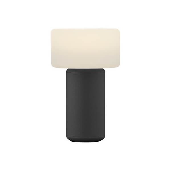 Lampe de face sur fond blanc, abat-jour ivoire et socle noir cylindrique