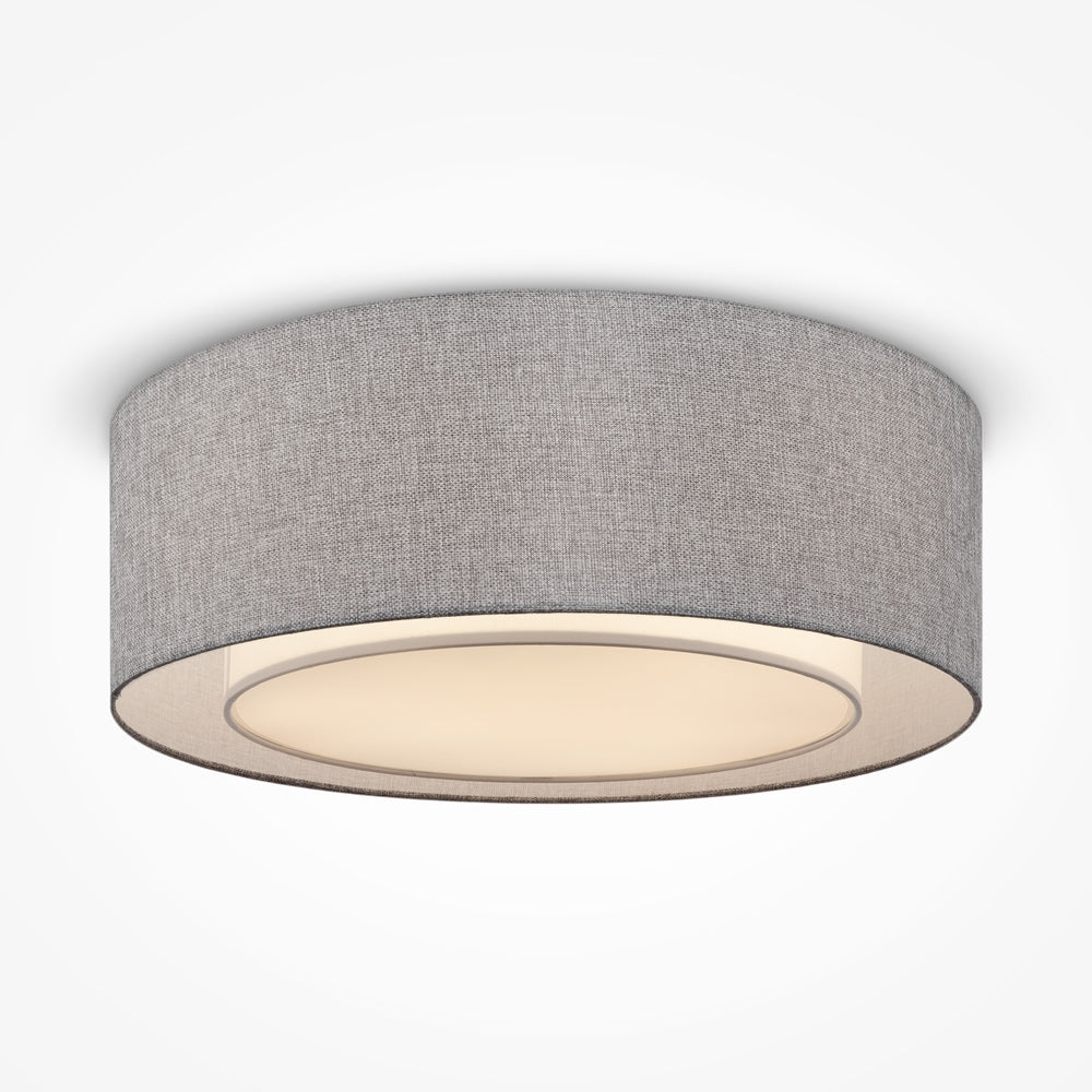 Plafonnier cylindrique vu de face, abat-jour en textile gris et large diffuseur blanc