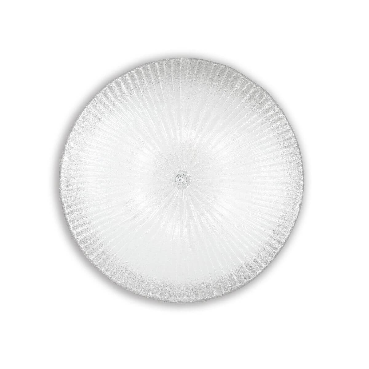 Plafonnier rond en verre transparent vu de dessous, côtes rayonnantes depuis le centre