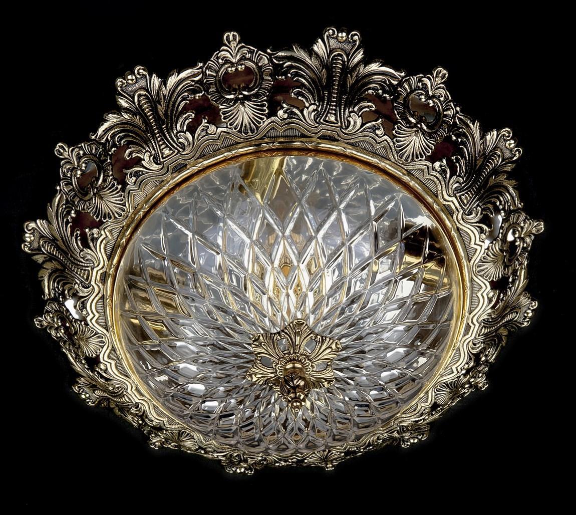 Lustre rond doré vu de face, éteint, sur fond noir