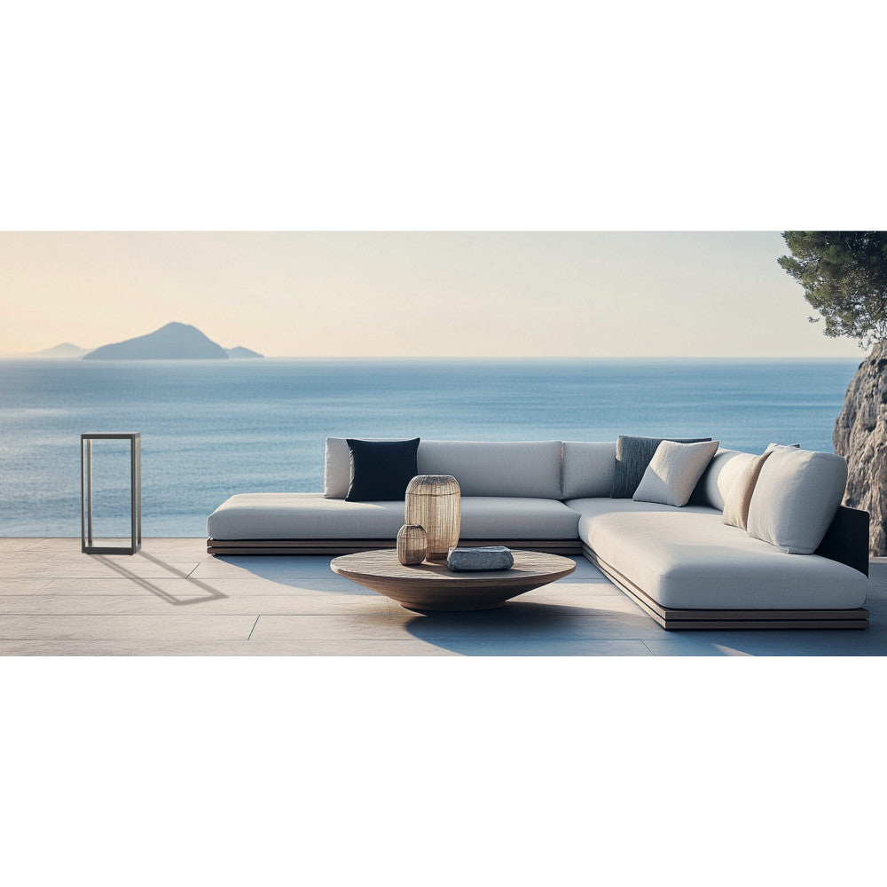 Mise en scène face à la mer, luminaire design à côté d'un canapé lounge