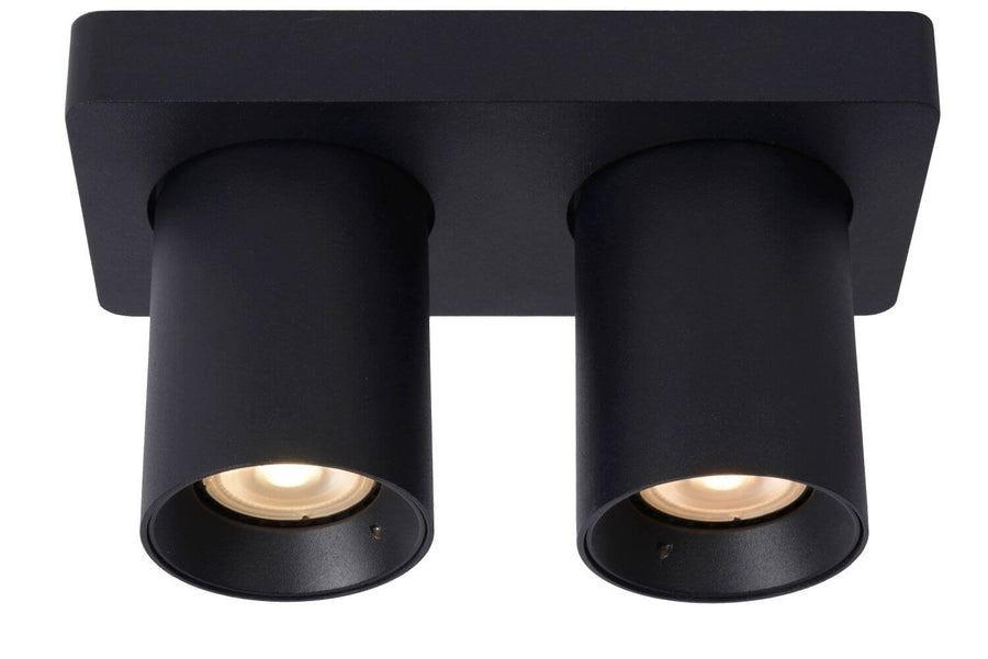 Vue de face du plafonnier noir avec deux cylindres orientables vers le bas.