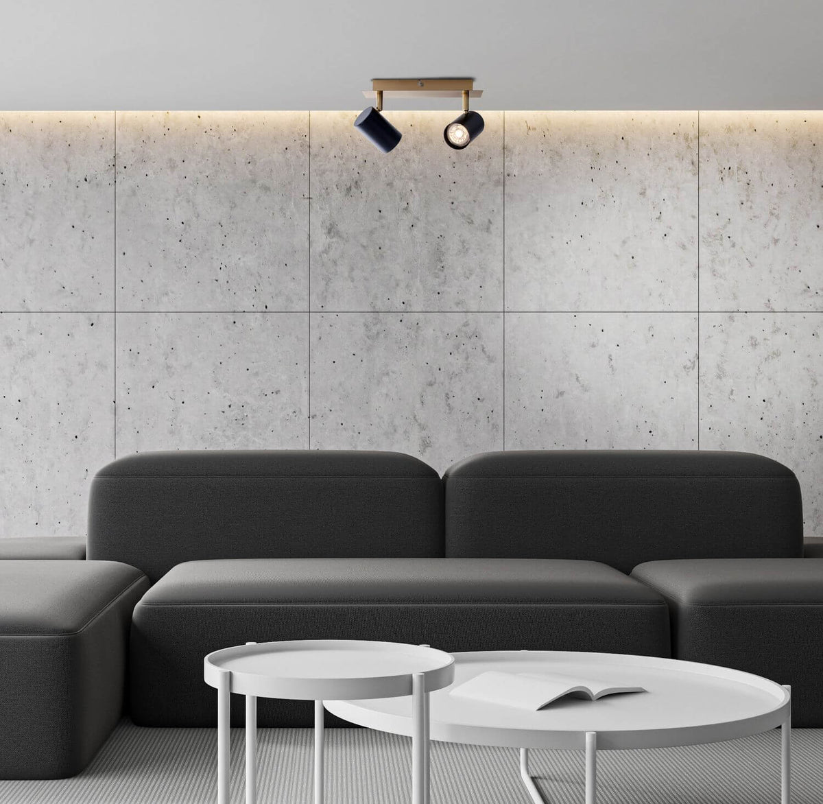 Mise en ambiance dans un salon contemporain, plafonnier fixé au plafond au-dessus d'un canapé gris.