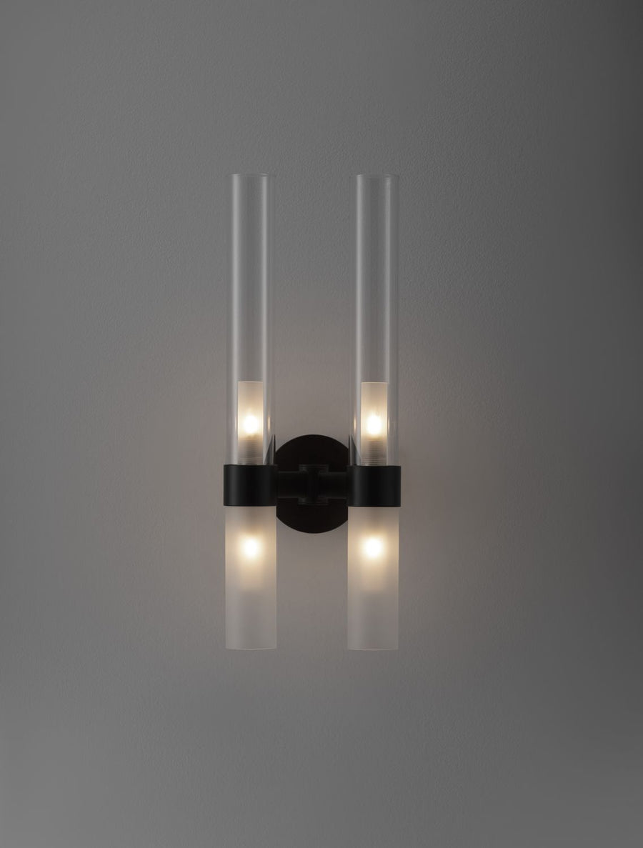 Applique allumée sur mur gris, halos lumineux diffusés vers le haut et le bas