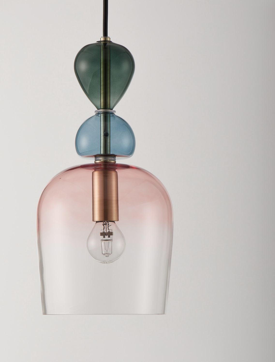 Gros plan sur la suspension et ses trois éléments en verre coloré superposés.