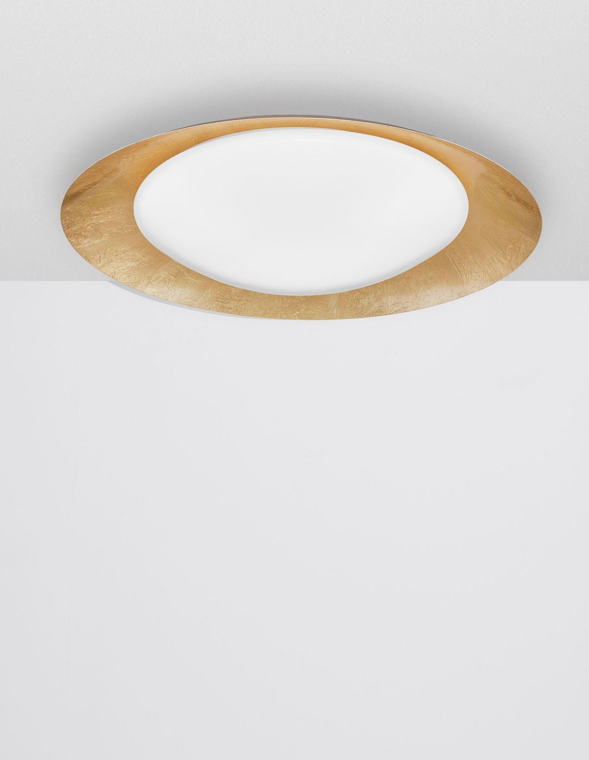 Plafonnier posé au plafond, vue de face montrant l'anneau doré et le verre blanc