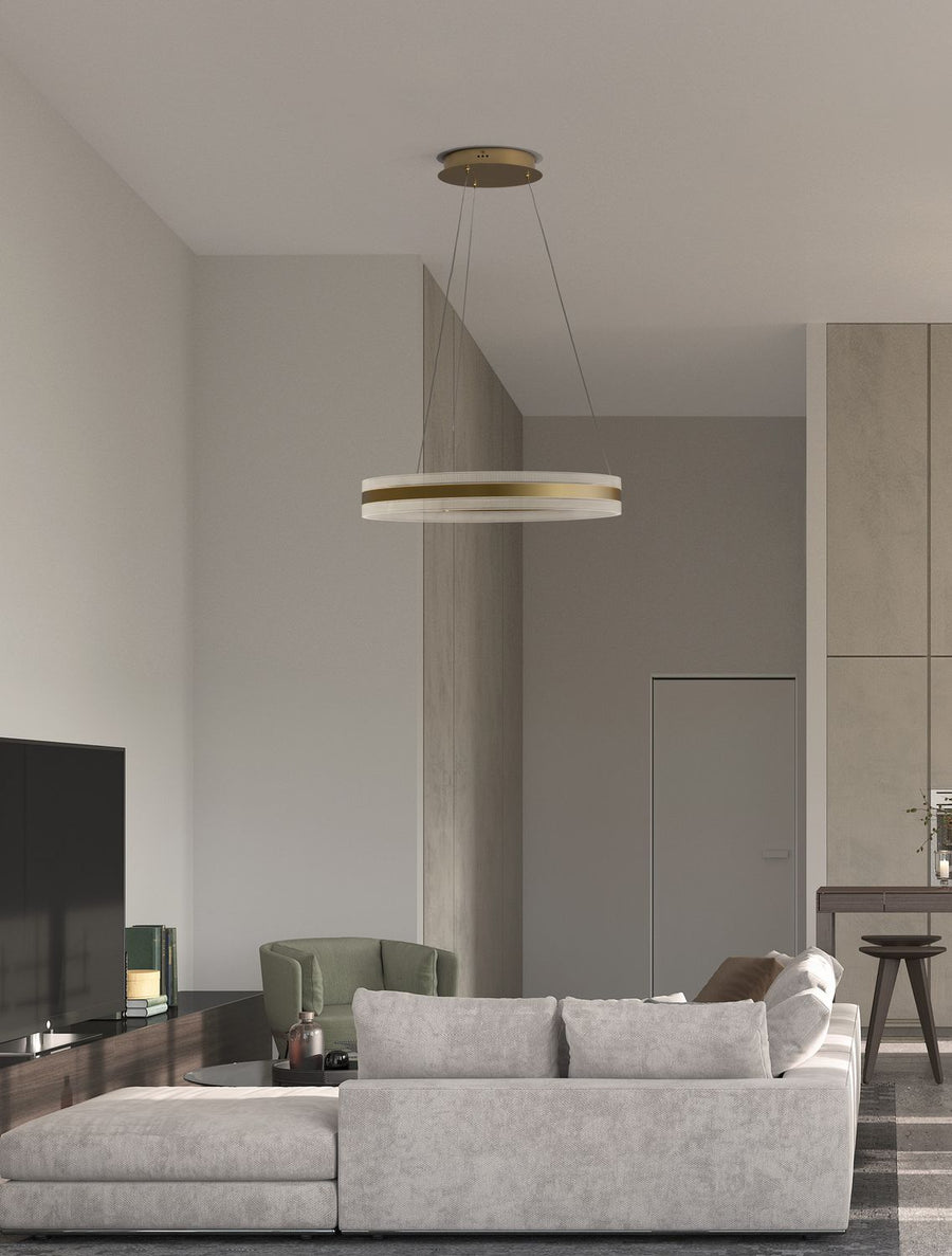 Suspension anneau dorée allumée dans un salon contemporain, au-dessus du canapé