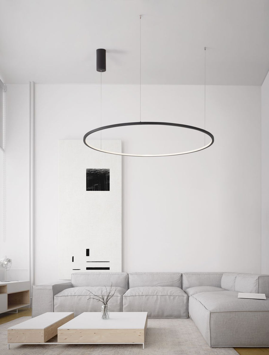 Suspension anneau noire installée au-dessus d'un salon clair et minimaliste