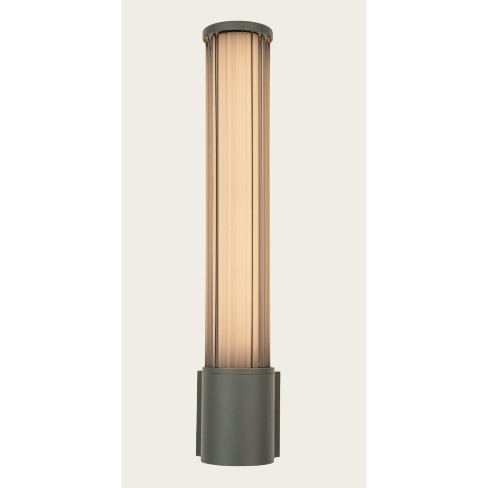 Vue rapprochée allumée, cylindre en verre strié diffusant une lumière chaude au-dessus de la base.