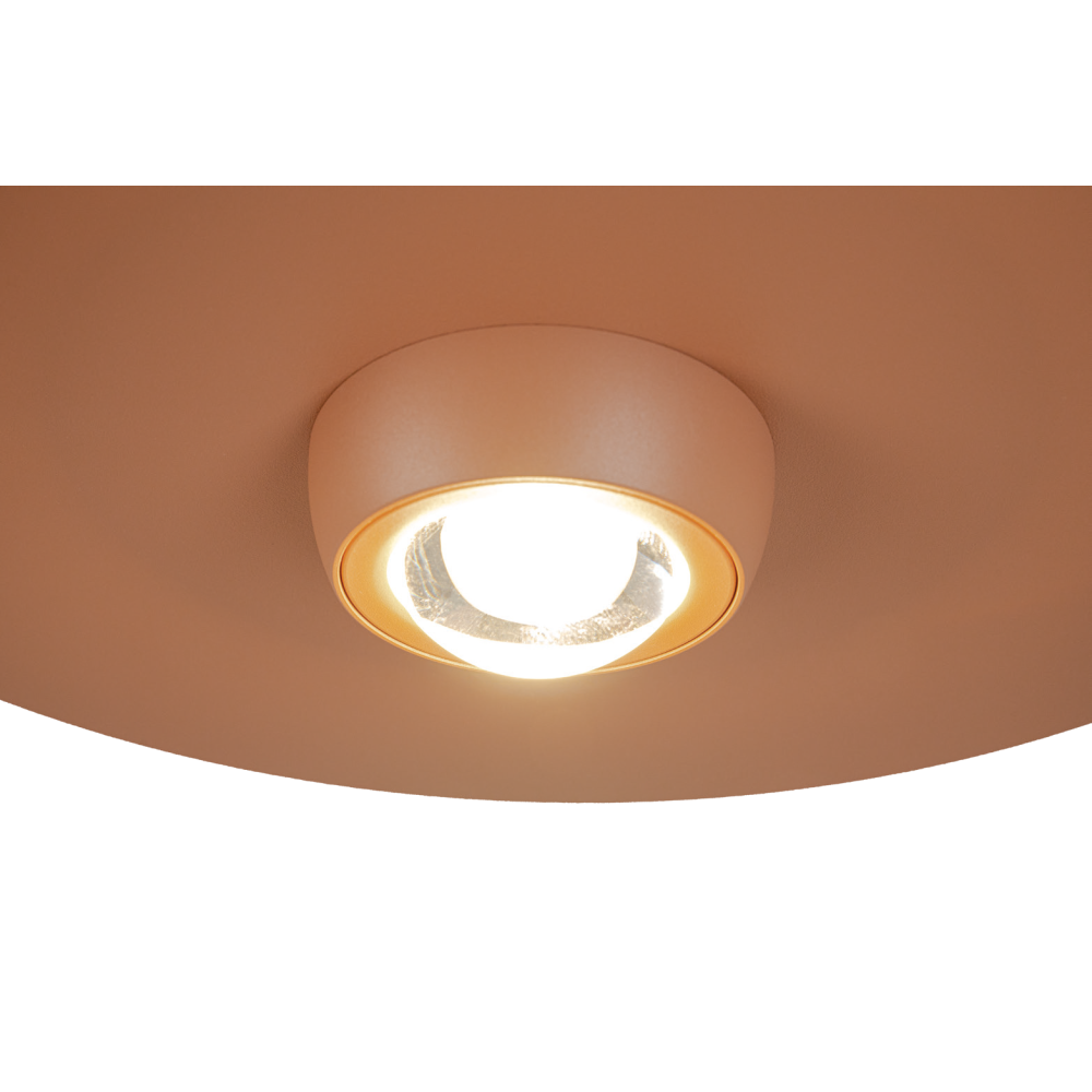 Détail rapproché de la source LED allumée sous le disque terracotta
