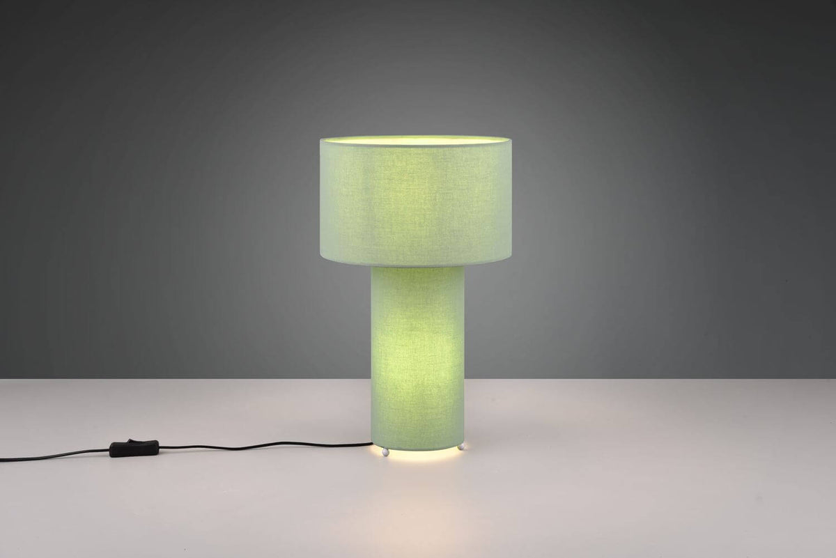 Vue rapprochée de la lampe cylindrique allumée, socle diffusant une lumière chaude