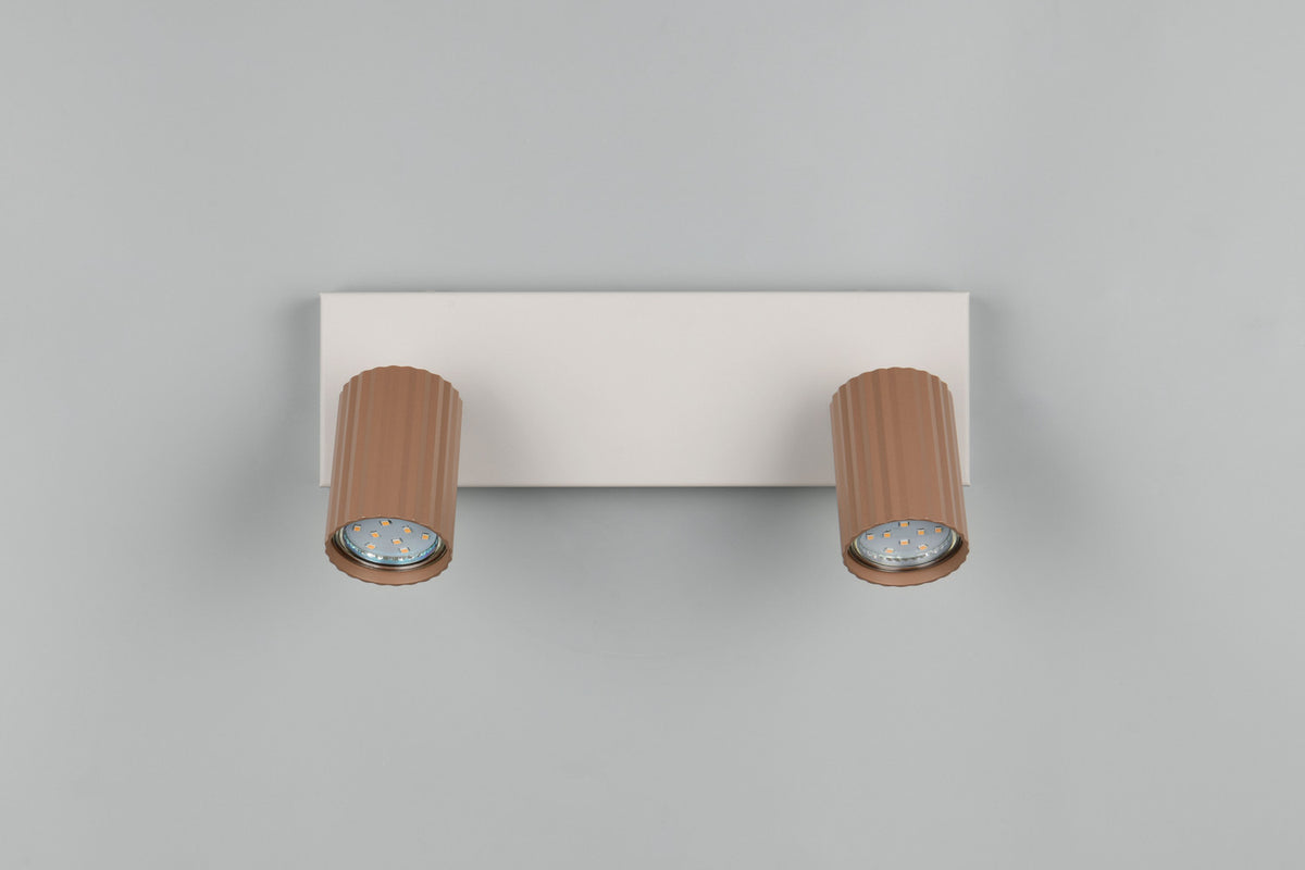 Vue frontale du luminaire avec deux têtes cylindriques striées, LED apparentes, sans éclairage.