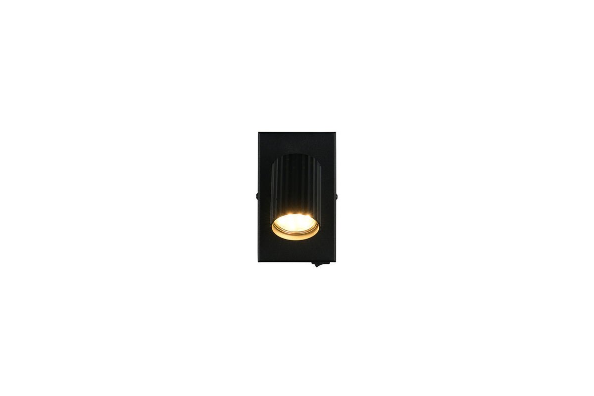 Vue de face du spot noir, plaque rectangulaire et cylindre lumineux central.