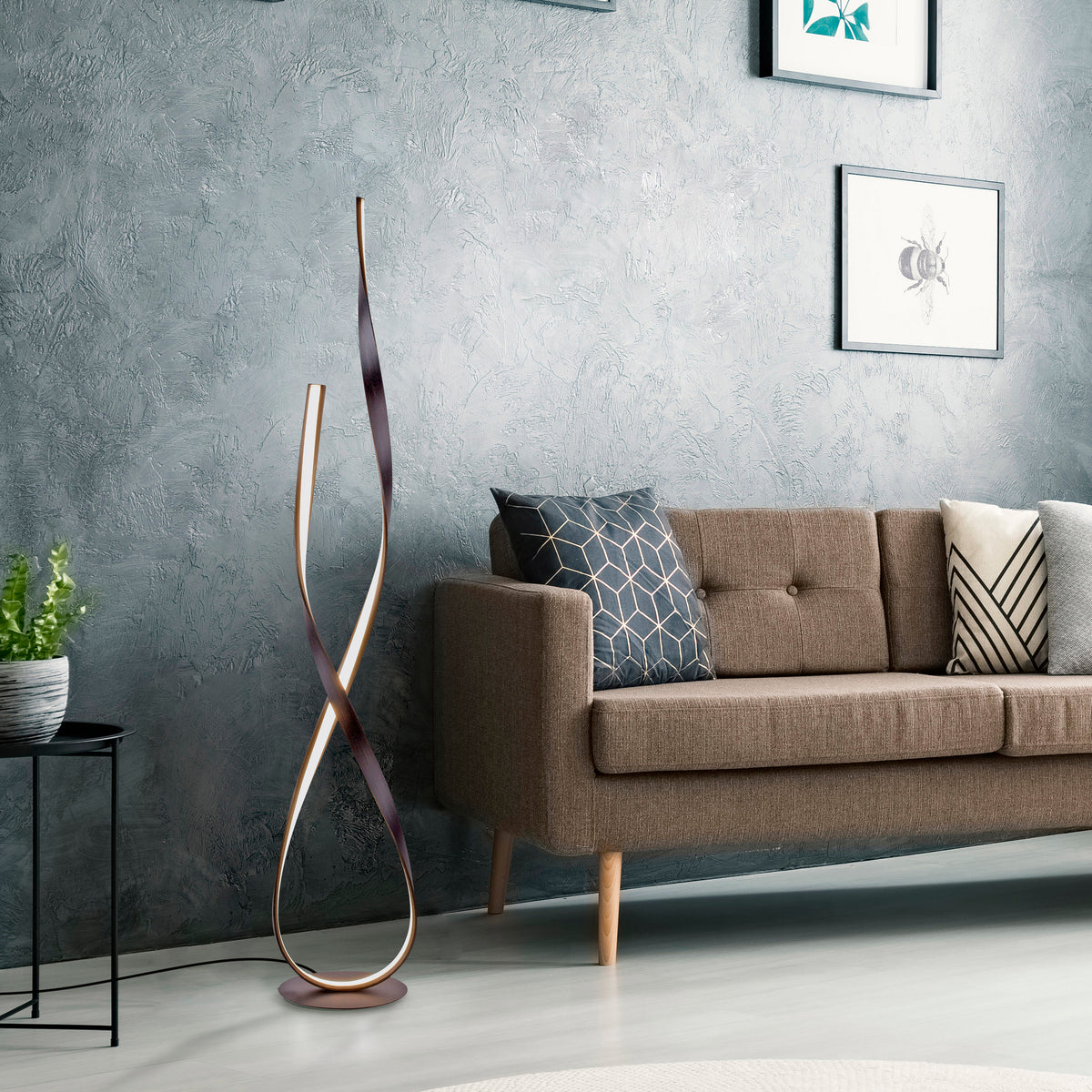 Mise en ambiance dans un salon moderne, lampadaire doré installé près d'un canapé en tissu.