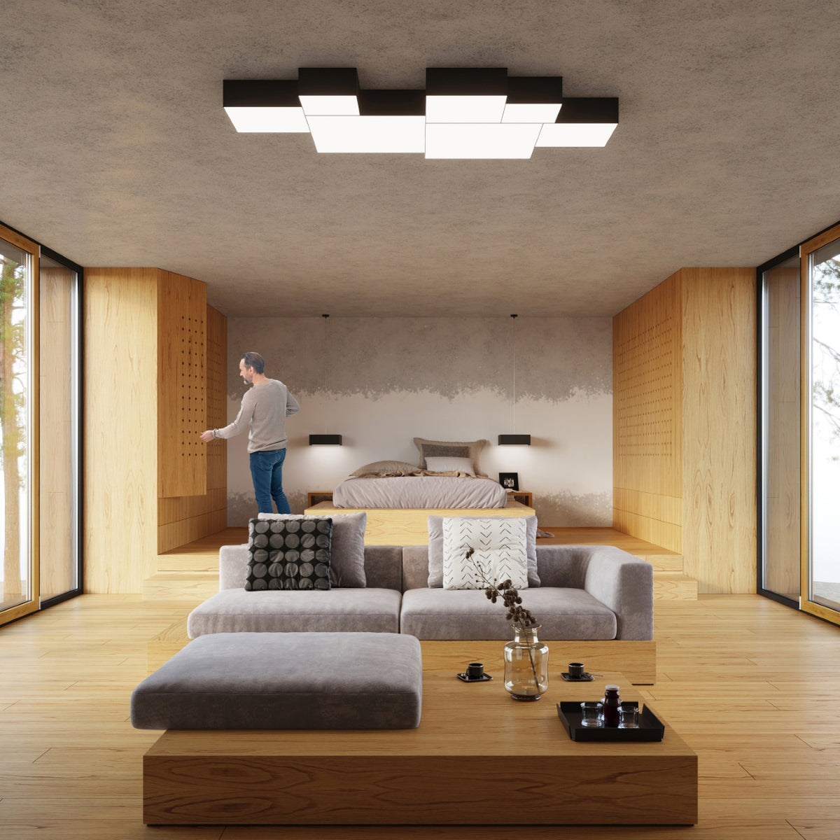 Mise en ambiance dans un salon, plusieurs plafonniers carrés noirs et blancs allumés au plafond.