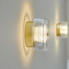 Applique murale LED Glow en acier, doré mat et transparent, Ø 16 cm