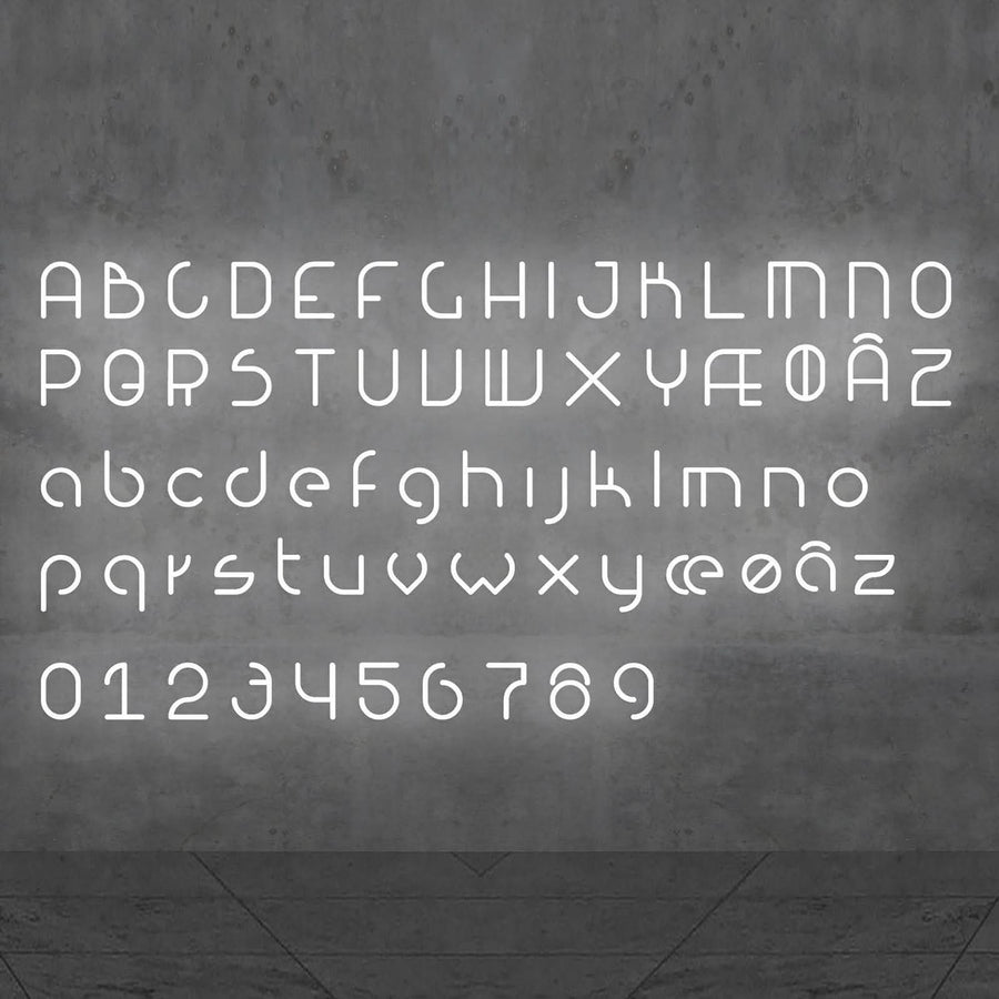 Alphabet complet en lettres lumineuses blanches présenté sur un fond gris.