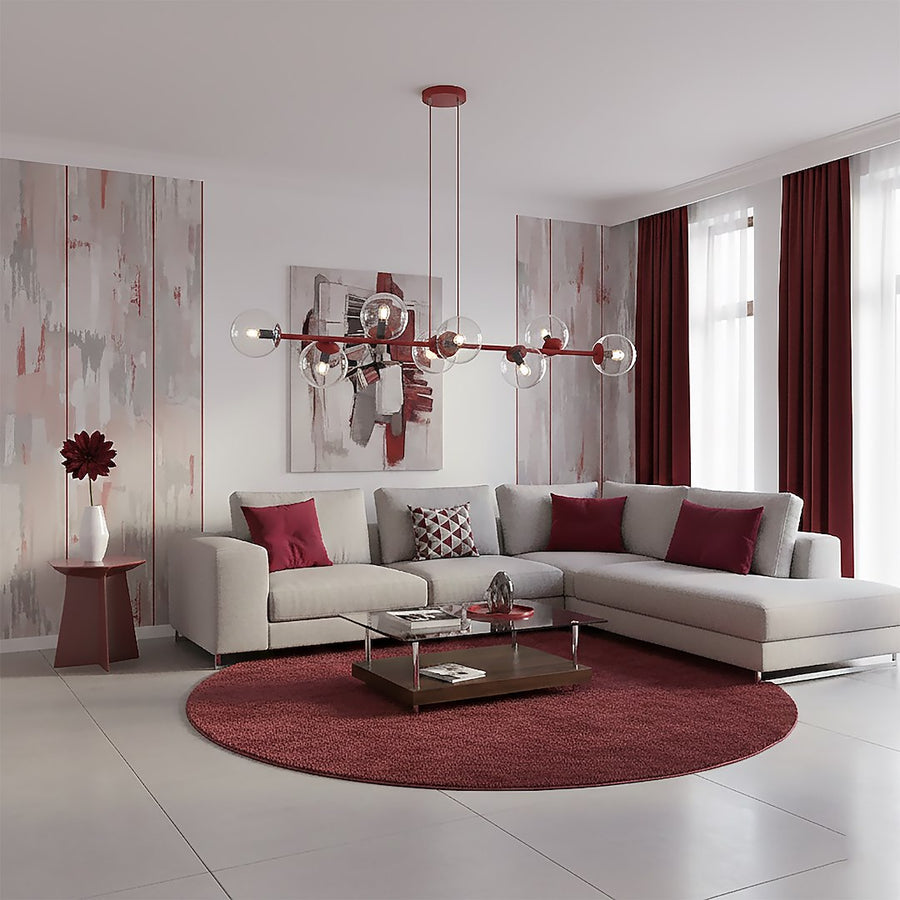 Mise en ambiance séjour avec canapé d'angle beige, tapis rond bordeaux et tableaux
