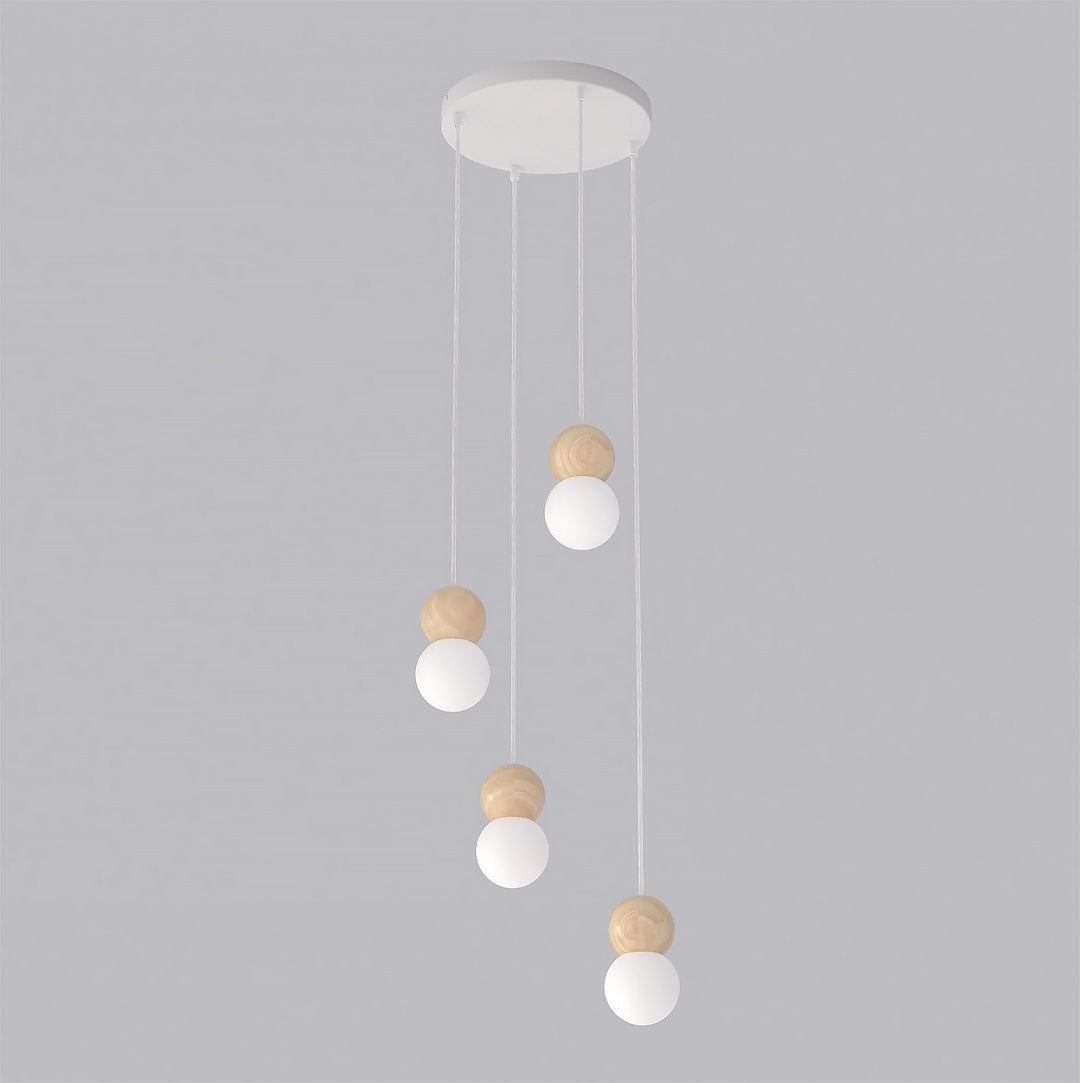 Vue de trois quarts du luminaire, quatre globes suspendus à des hauteurs différentes