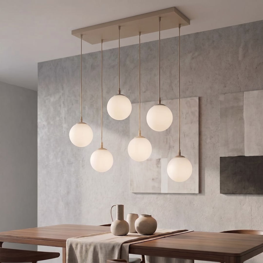 Suspension allumée dans un intérieur contemporain, mur béton et table en bois