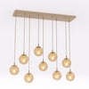 Suspension Cosmo 9 lumières beige, verre ambré