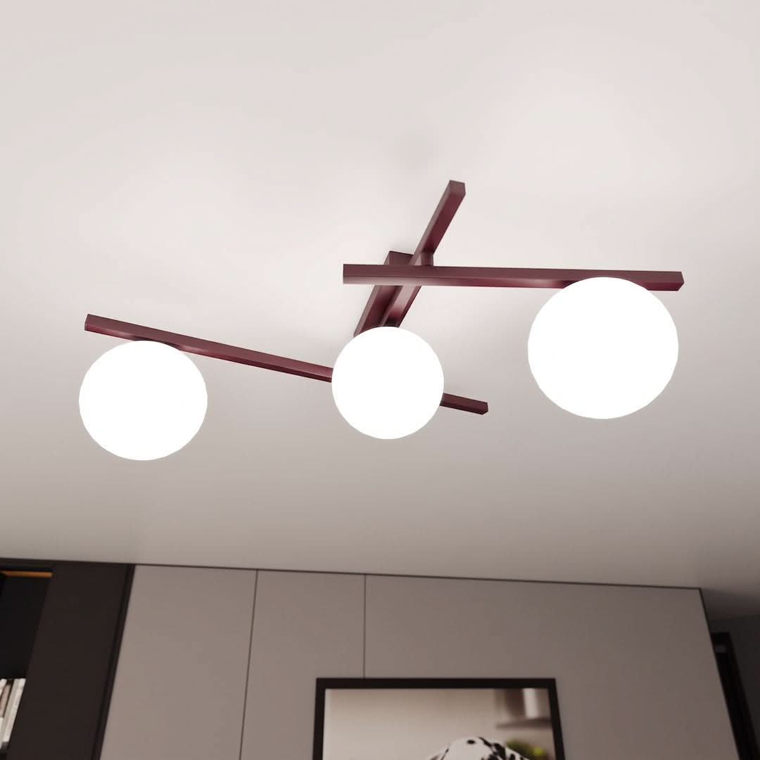 Luminaire fixé au plafond blanc, trois globes allumés, structure croisée vue de dessous