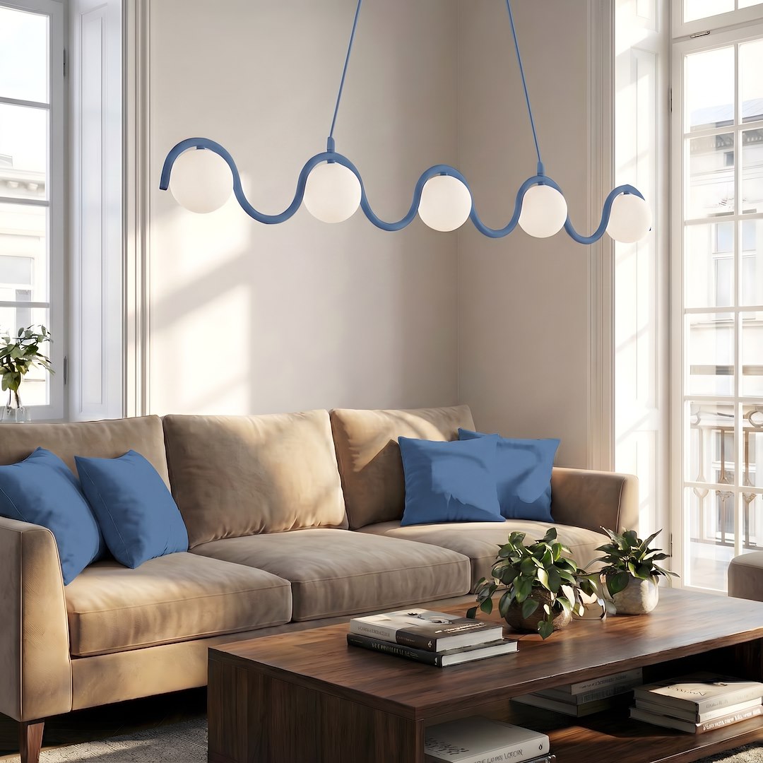 Ambiance séjour avec canapé beige, coussins bleus et grandes fenêtres