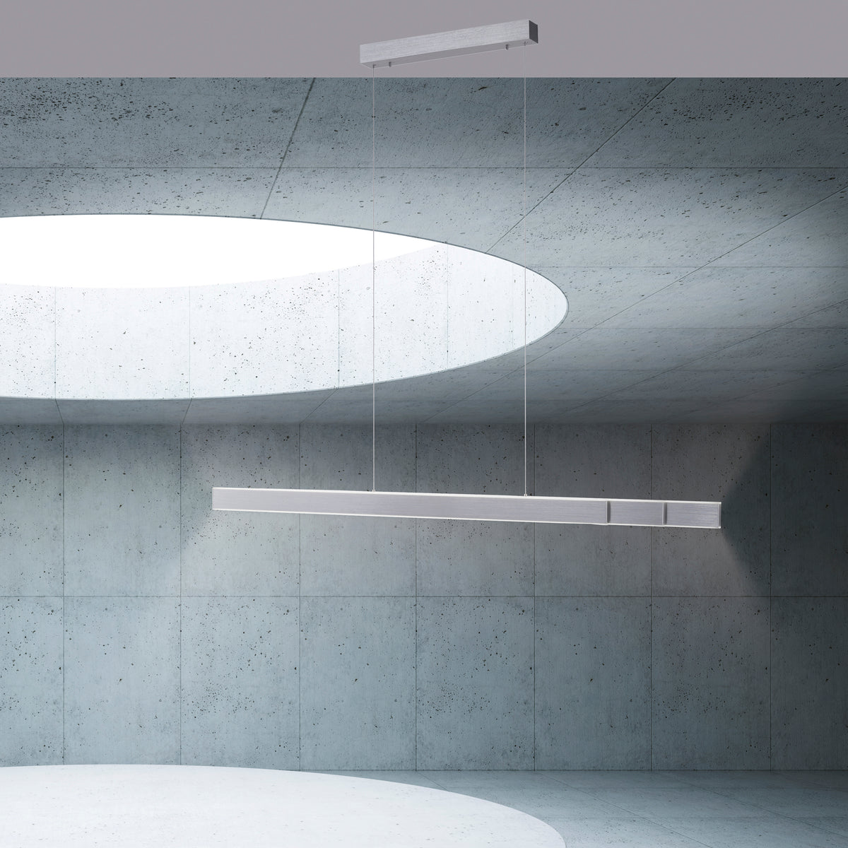 Mise en ambiance dans un intérieur béton, suspension linéaire éclairant vers le haut et le bas.