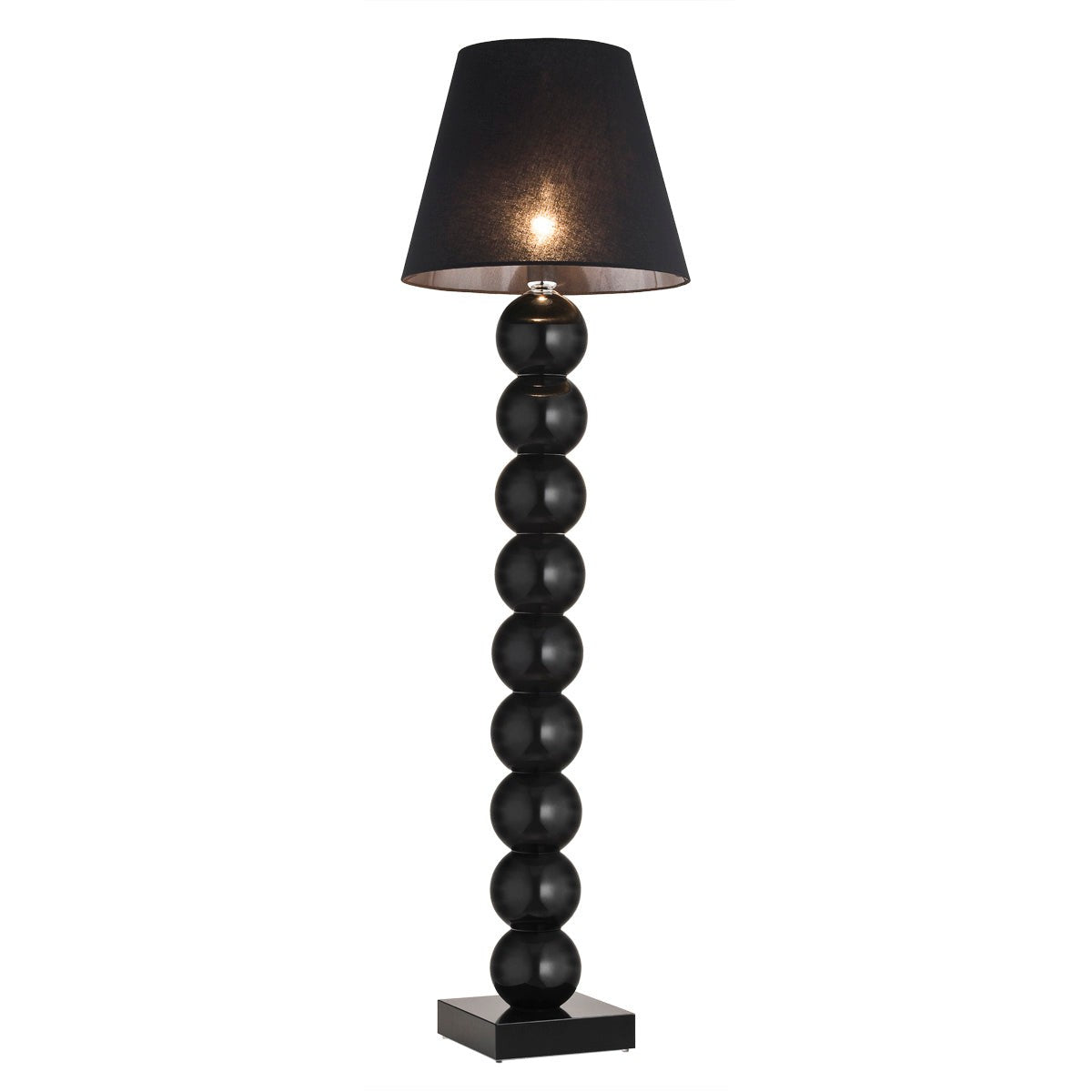 Lampadaire noir brillant à boules superposées et abat-jour noir allumé, fond blanc.