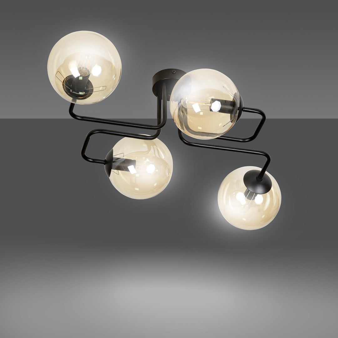 Luminaire allumé sur fond gris dégradé, verre ambré transparent et lumineux.
