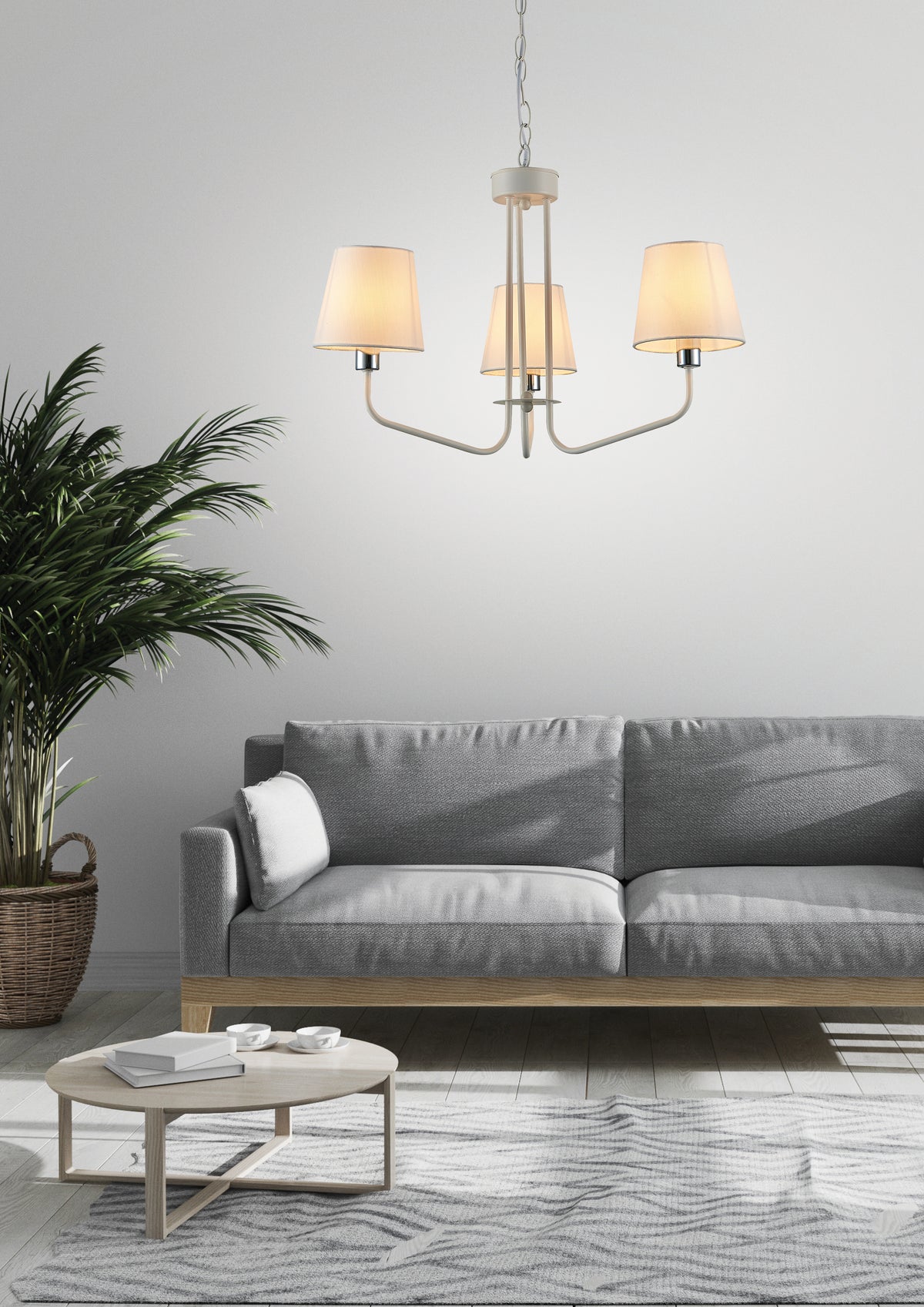 Luminaire suspendu installé au-dessus d'un canapé gris dans un salon clair