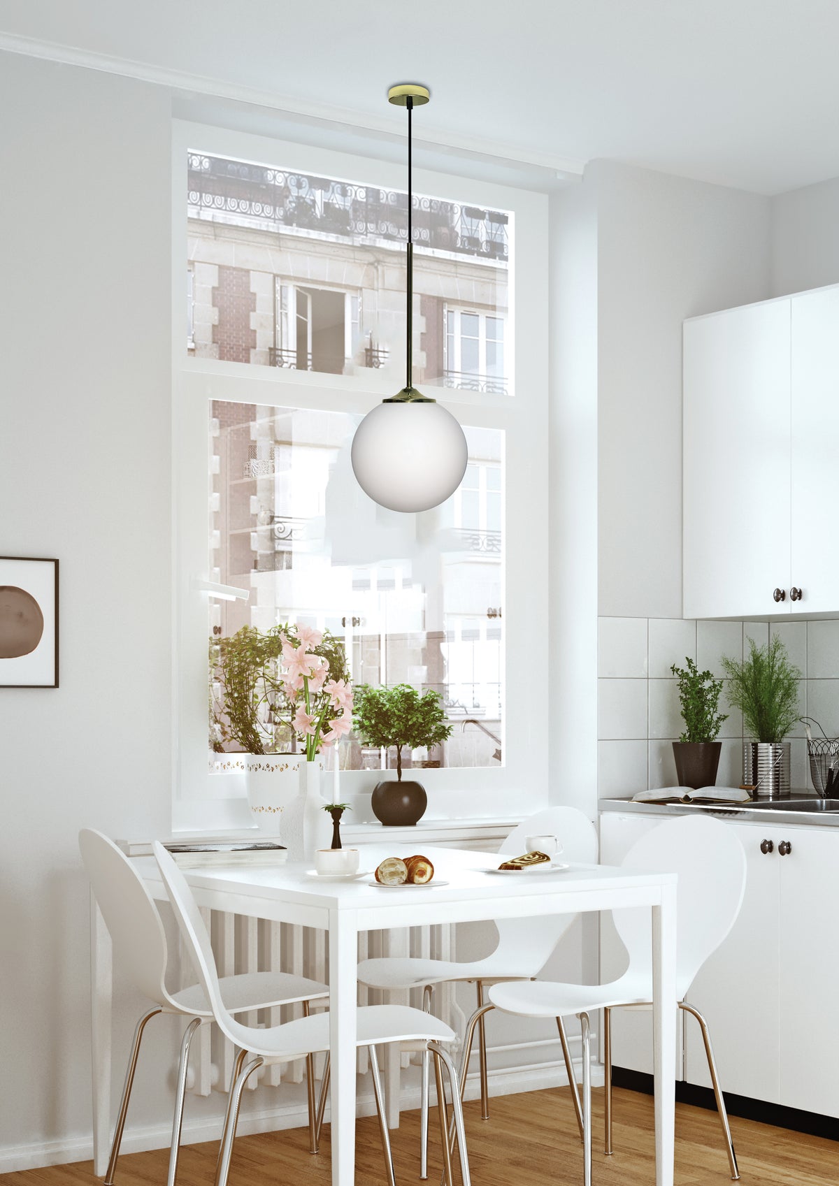 Suspension globe allumée au-dessus d'une table blanche dans une cuisine lumineuse