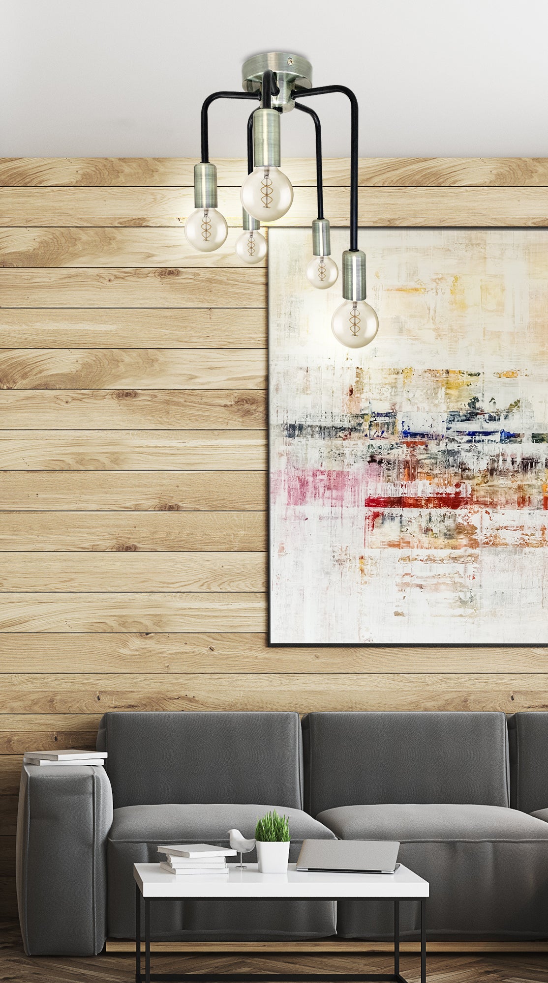 Plafonnier installé au-dessus d'un canapé gris, ambiance salon avec tableau abstrait.
